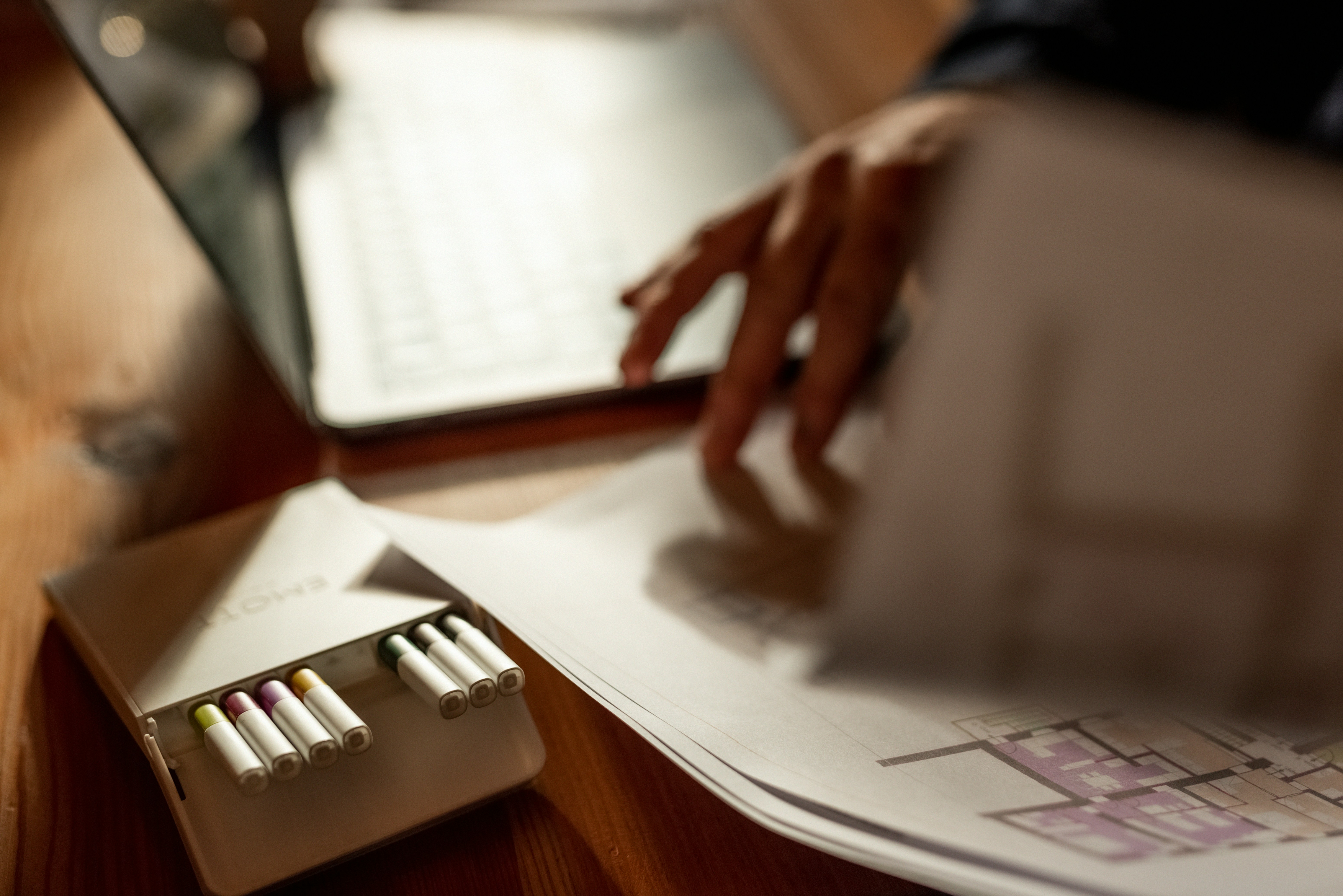 Close view of an invoice on aged paper, beside a pen, amber lamp, and handwritten marginal notes on each line item